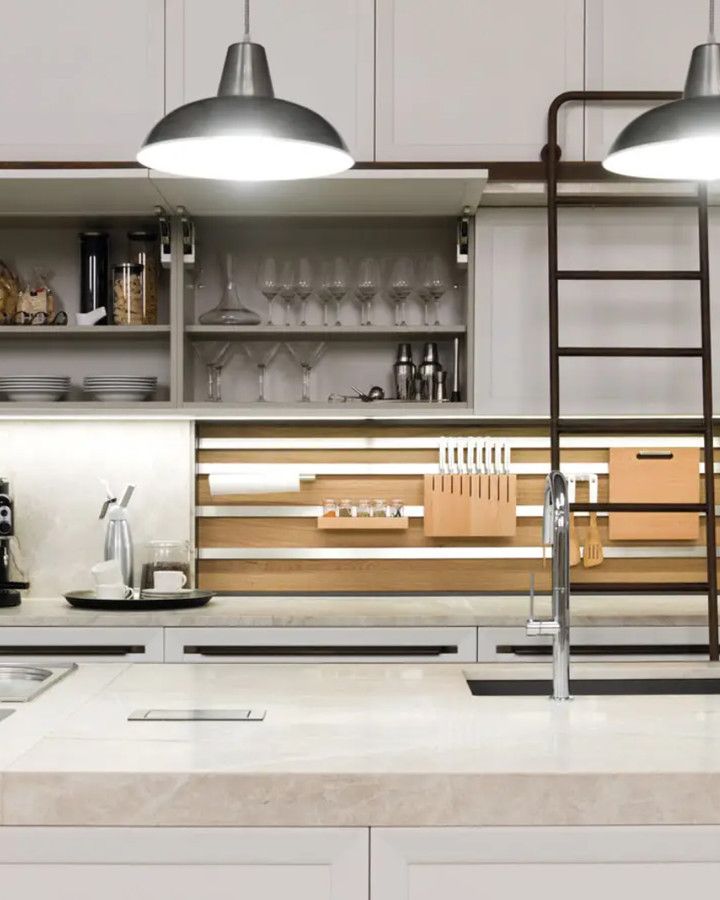 Kitchen with pale cabinets, open shelves and a stone island