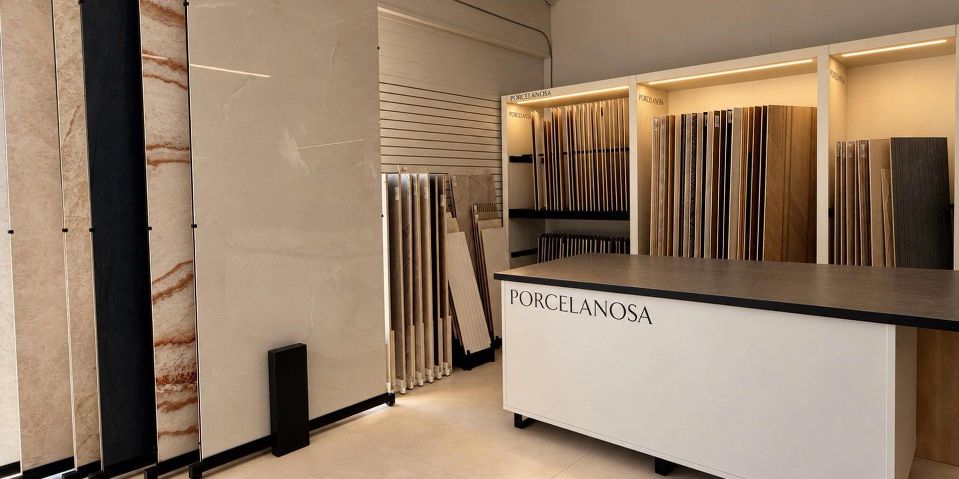 The Porcelanosa corner of our Sarasota showroom: a counter in front of large porcelain slabs