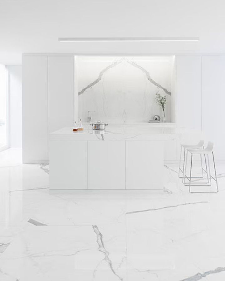 White kitchen with a white marble-look floor